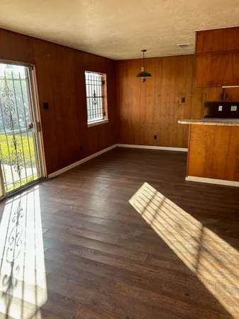 wooden floor in an empty room with a window