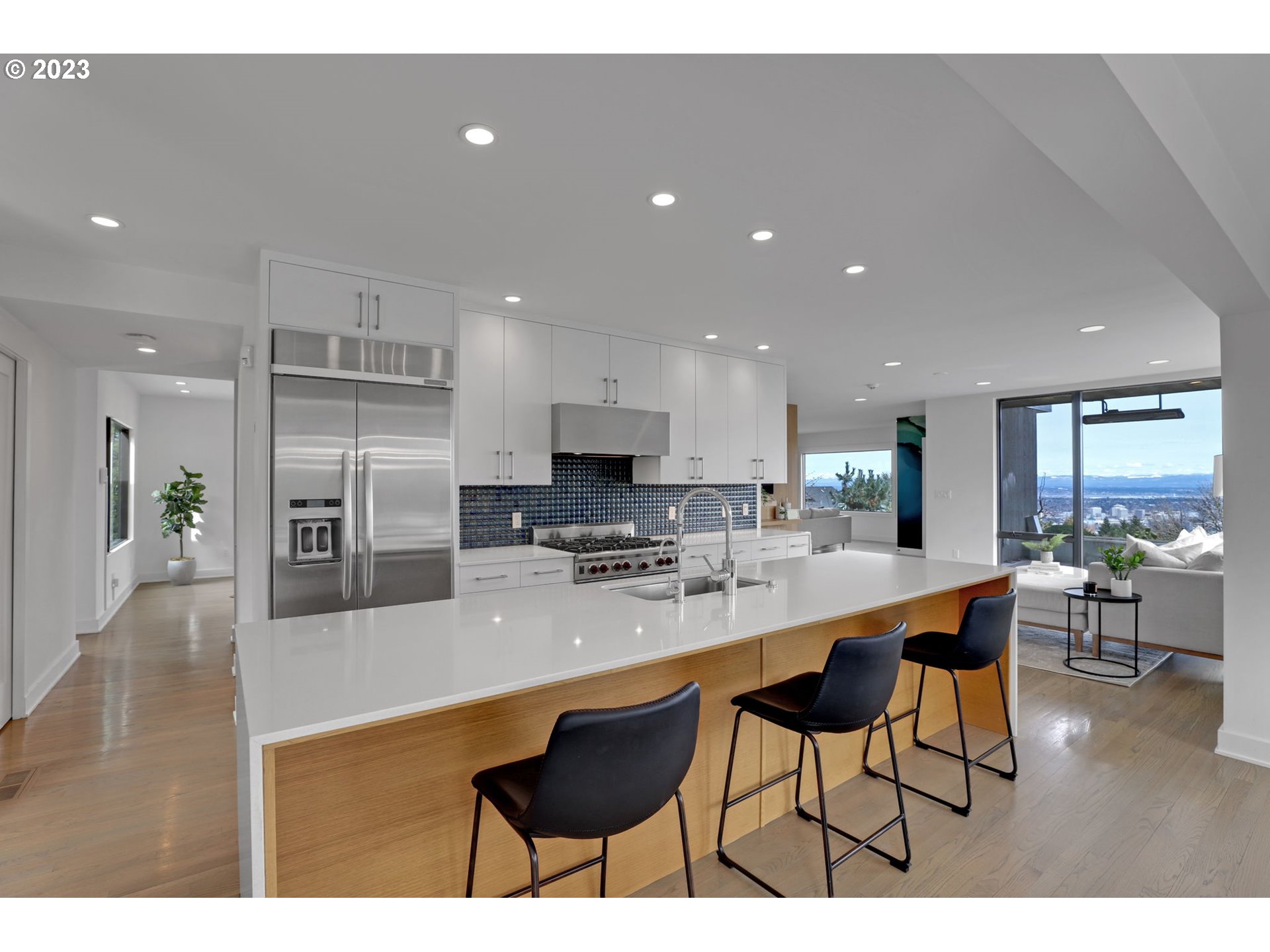 4409 Southwest Carl Place Portland, OR 97239 - Photo 13 of 32 a large kitchen with a table and chairs in it