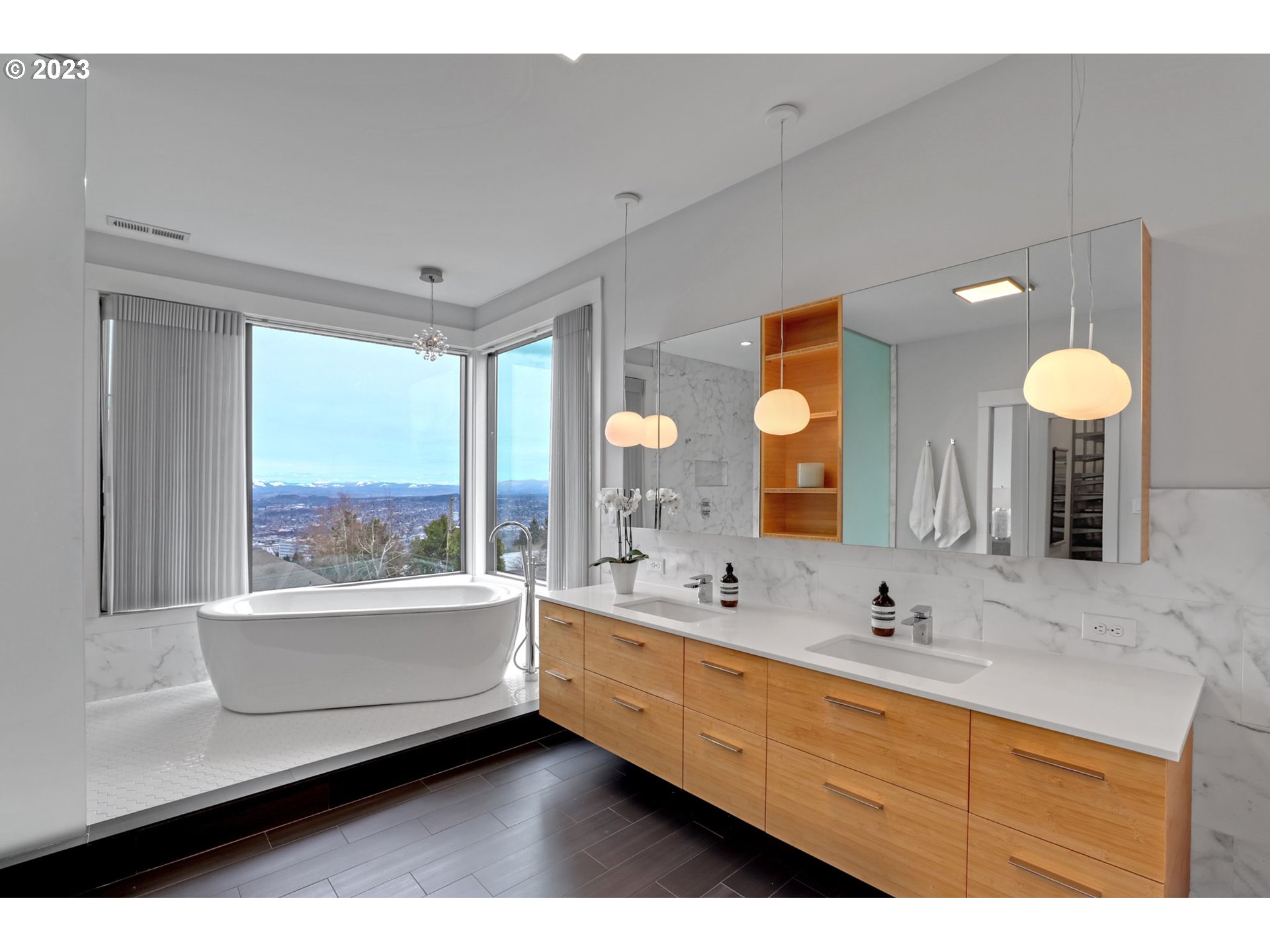 4409 Southwest Carl Place Portland, OR 97239 - Photo 23 of 32 a bathroom with a double vanity sink and a large mirror