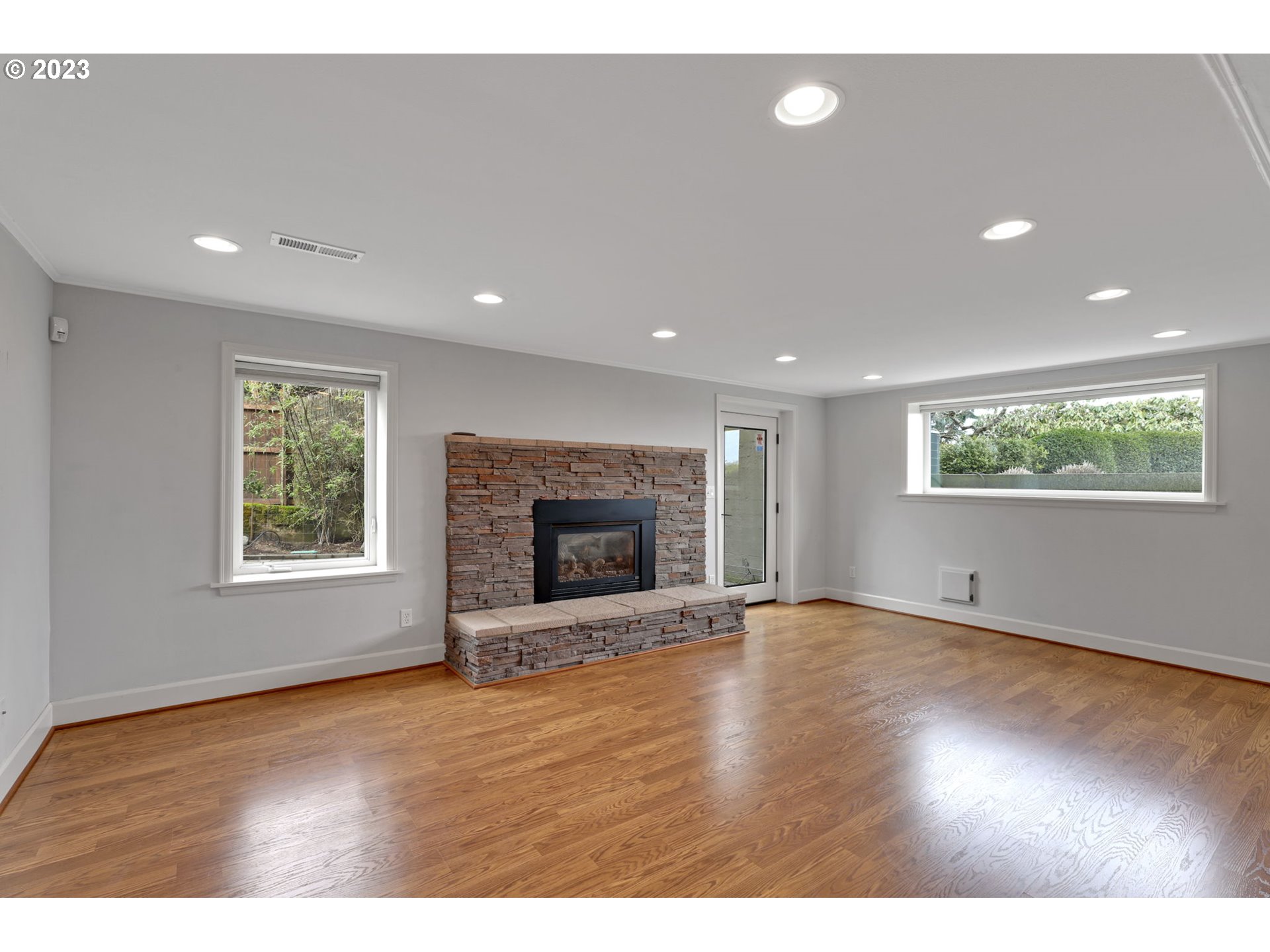4409 Southwest Carl Place Portland, OR 97239 - Photo 24 of 32 a view of an empty room with wooden floor and a window
