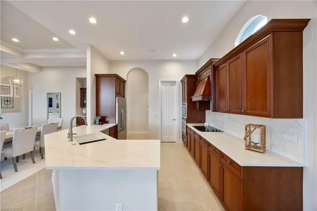 a large kitchen with kitchen island a sink stainless steel appliances and cabinets