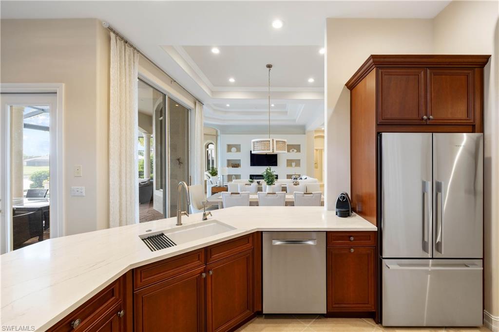 8950 Shenendoah Circle Naples, FL 34113 - Photo 47 of 48 a kitchen with a sink stainless steel appliances and cabinets