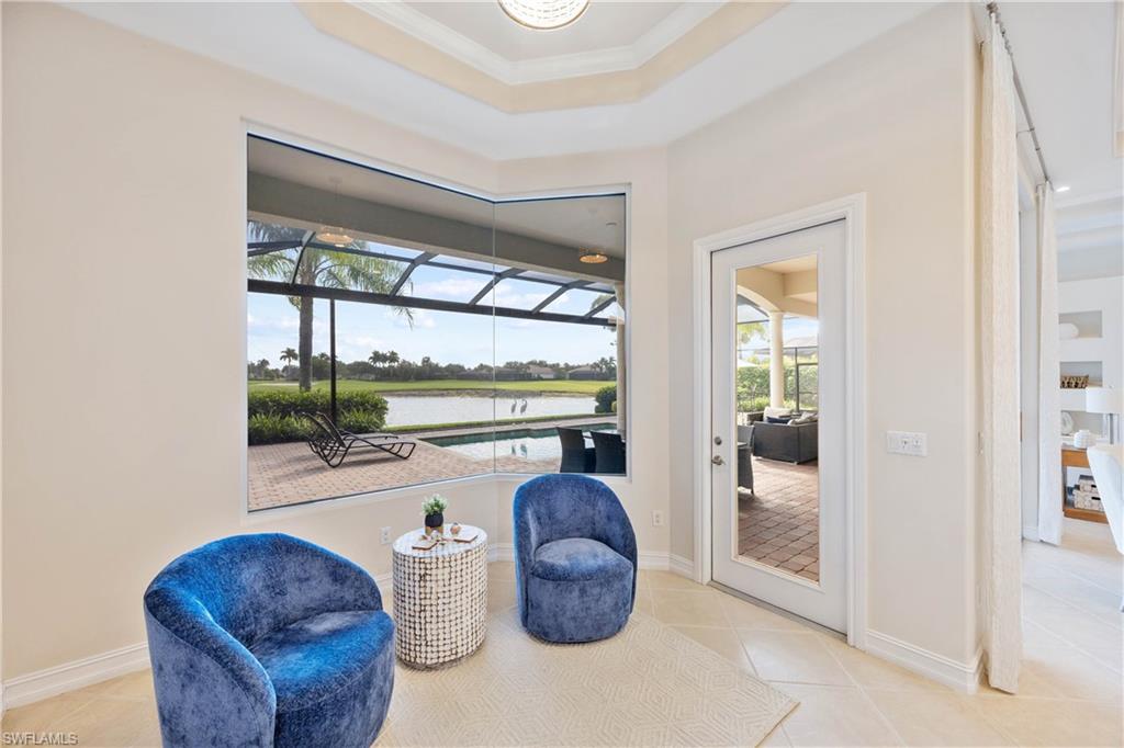 8950 Shenendoah Circle Naples, FL 34113 - Photo 13 of 48 a living room with furniture a floor to ceiling window and potted plant