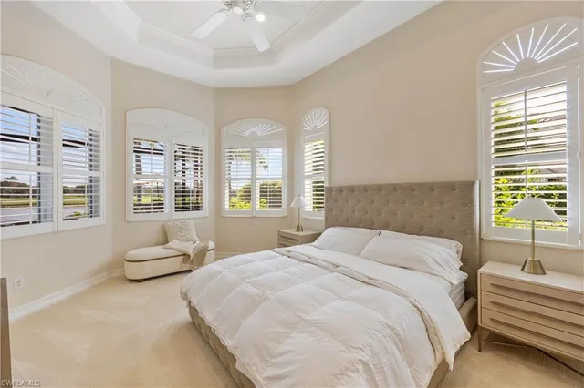 a living room with furniture a floor to ceiling window and potted plant