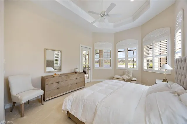 a bedroom with a bed and windows