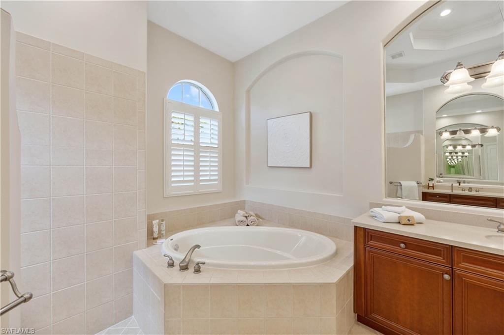 8950 Shenendoah Circle Naples, FL 34113 - Photo 17 of 48 a bathroom with a sink and a mirror