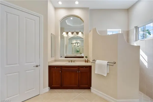 a spacious bathroom with a double vanity sink mirror and double