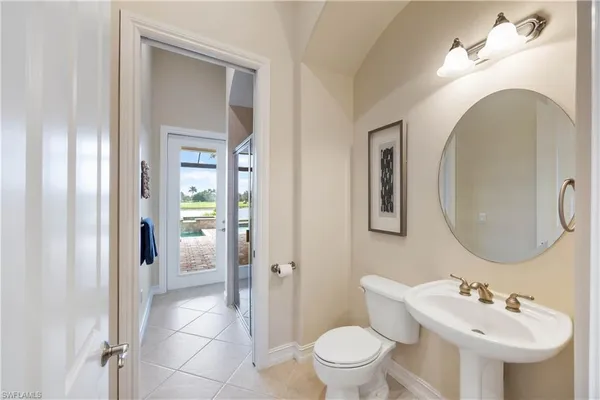 a bathroom with a granite countertop sink a mirror and a shower