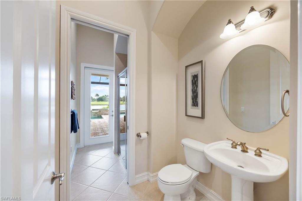 8950 Shenendoah Circle Naples, FL 34113 - Photo 20 of 48 a bathroom with a toilet sink and mirror
