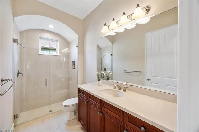 a bedroom with a bed and a chandelier fan