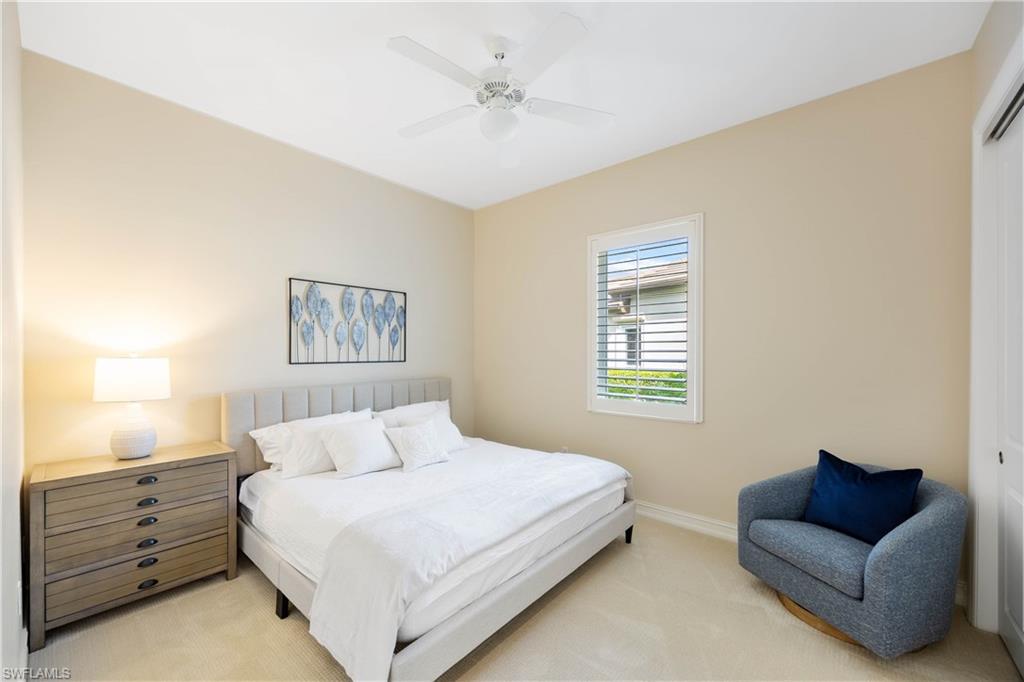 8950 Shenendoah Circle Naples, FL 34113 - Photo 25 of 48 a bedroom with a bed and a couch