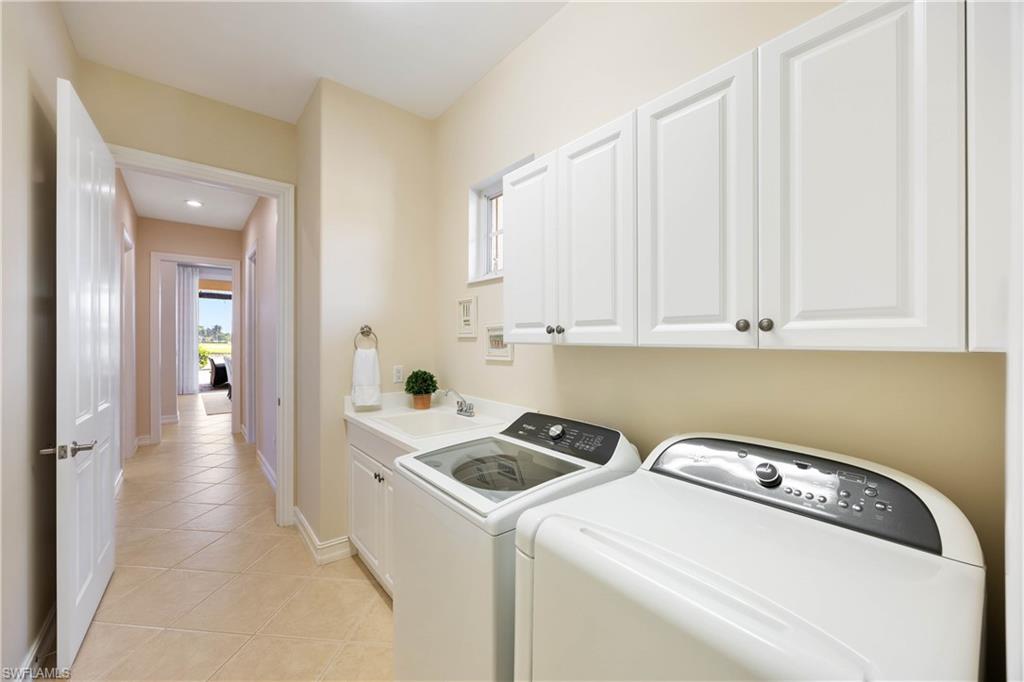 8950 Shenendoah Circle Naples, FL 34113 - Photo 26 of 48 a utility room with dryer and washer