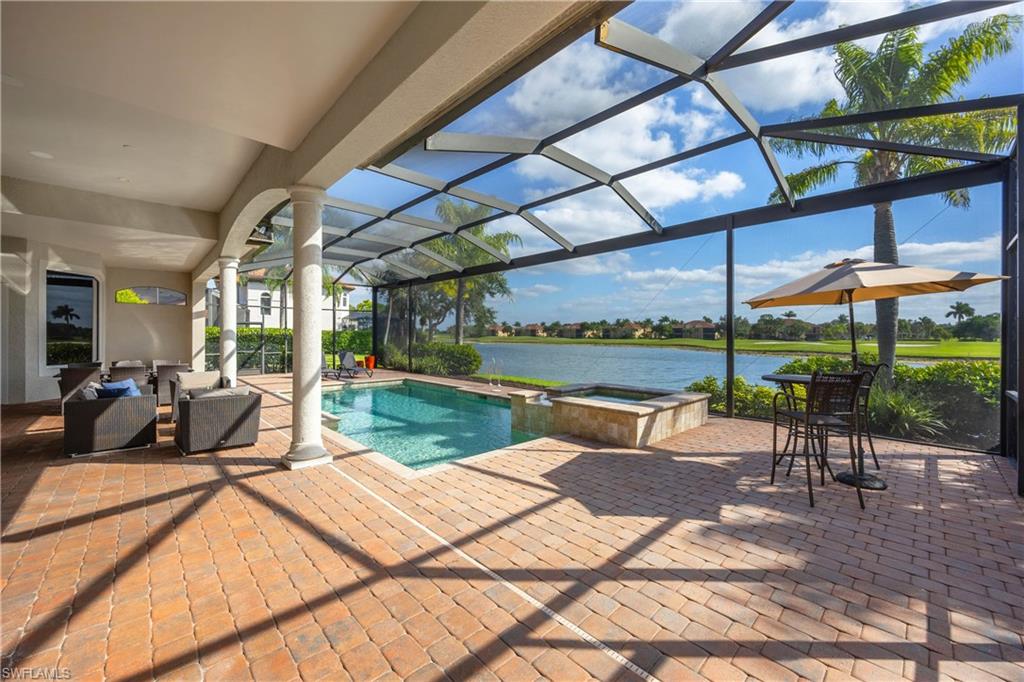 8950 Shenendoah Circle Naples, FL 34113 - Photo 31 of 48 a view of a patio with a table and chairs under an umbrella