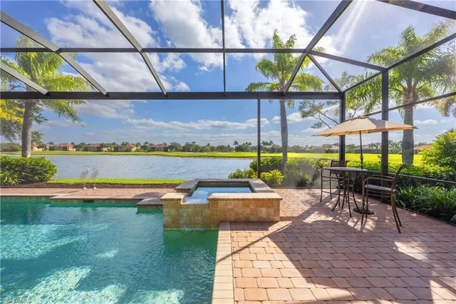 a view of a patio with a table and chairs under an umbrella