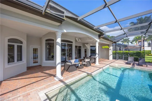a view of a house with backyard porch and sitting area