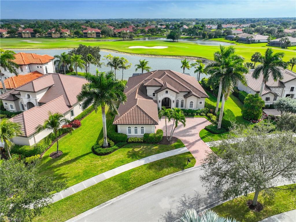 8950 Shenendoah Circle Naples, FL 34113 - Photo 38 of 48 an aerial view of a house with a swimming pool yard and outdoor seating