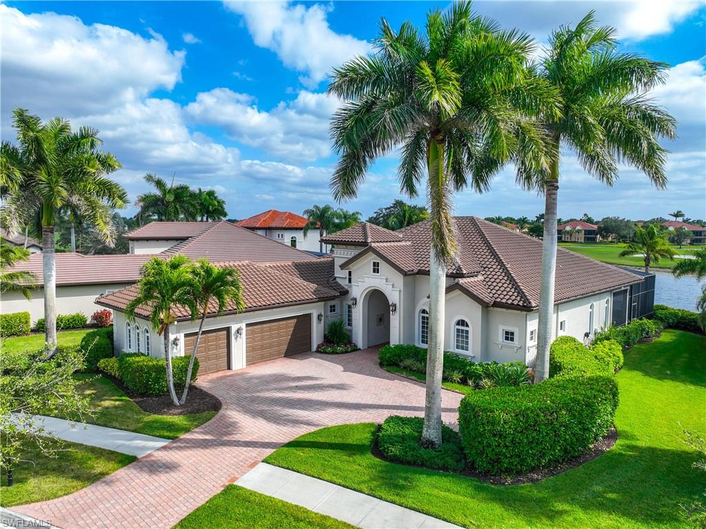 8950 Shenendoah Circle Naples, FL 34113 - Photo 39 of 48 a front view of a house with a yard and palm trees