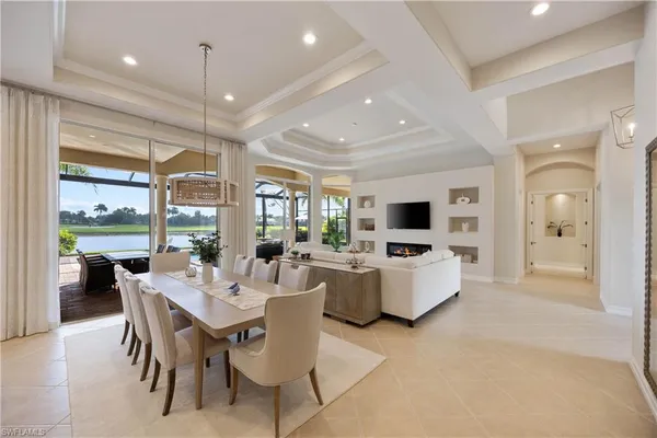a dining room with furniture a flat screen tv and a large window
