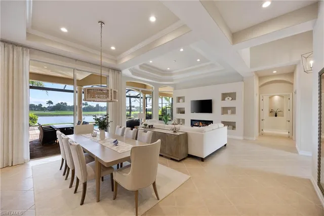 a dining room with furniture a flat screen tv and a large window