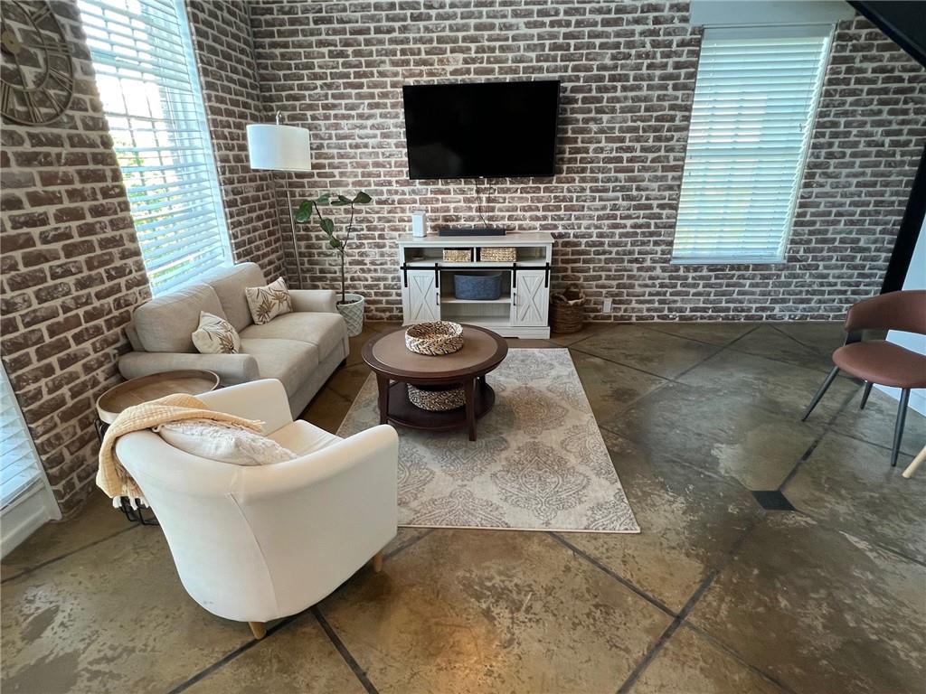 5434 Peachtree Road, Unit 119 Atlanta, GA 30341 - Photo 6 of 44 a view of a patio with couches chairs and a fireplace