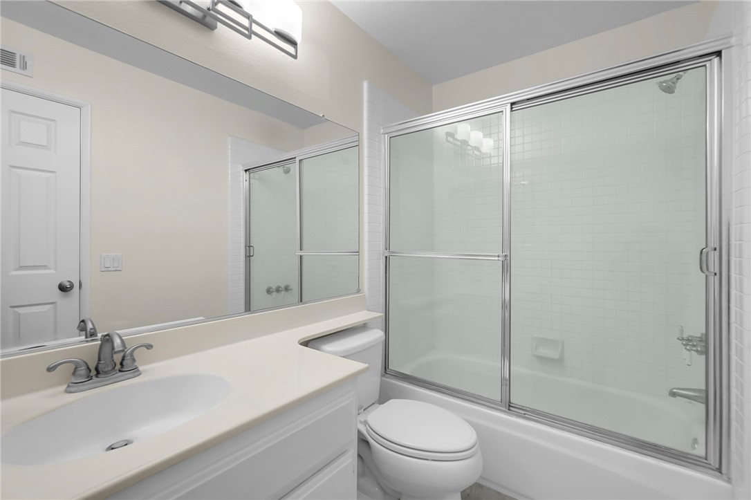 73 Cartier Aisle Irvine, CA 92620 - Photo 13 of 19 a bathroom with a sink toilet and shower