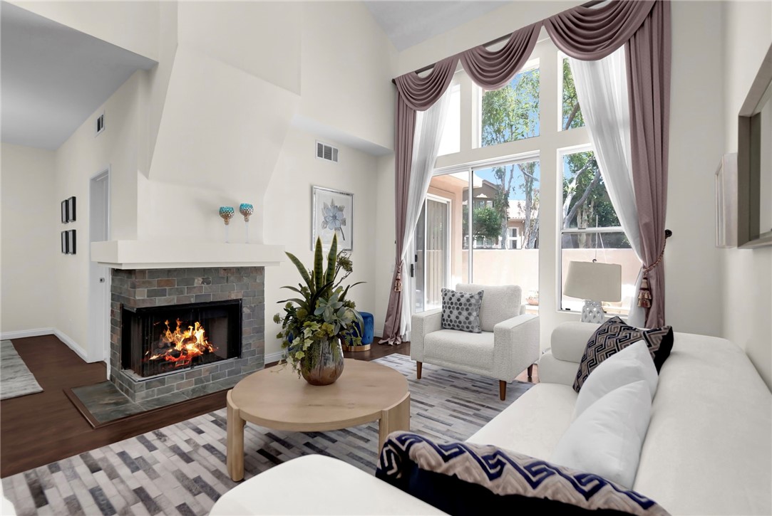 73 Cartier Aisle Irvine, CA 92620 - Photo 4 of 19 a living room with furniture fireplace and window