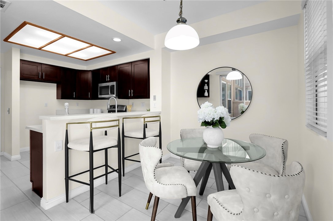 73 Cartier Aisle Irvine, CA 92620 - Photo 8 of 19 a living room with furniture a flat screen tv and kitchen view