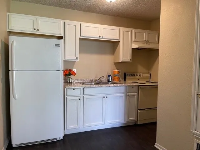 a white refrigerator freezer sitting inside of a kitchen