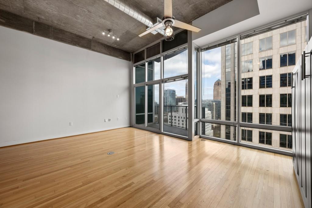 943 Peachtree Street Northeast, Unit 2009 Atlanta, GA 30309 - Photo 14 of 57 a view of an empty room with wooden floor and a window