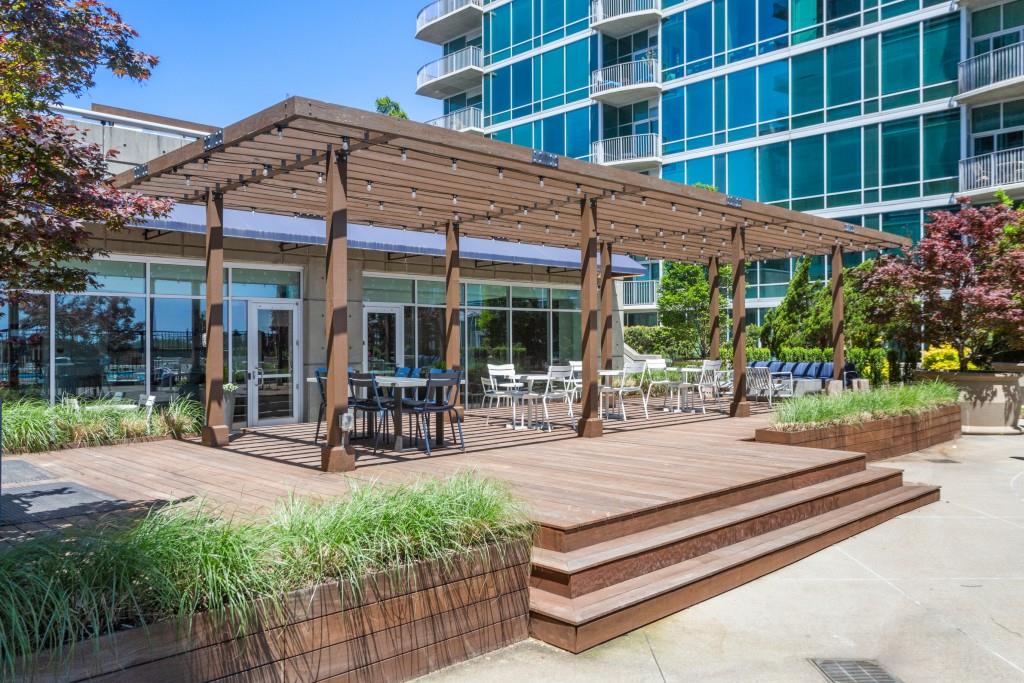 943 Peachtree Street Northeast, Unit 2009 Atlanta, GA 30309 - Photo 27 of 57 a view of a patio with a table and chairs under an umbrella