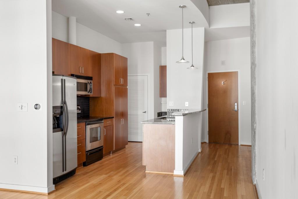 943 Peachtree Street Northeast, Unit 2009 Atlanta, GA 30309 - Photo 5 of 57 a kitchen with stainless steel appliances a refrigerator and a stove