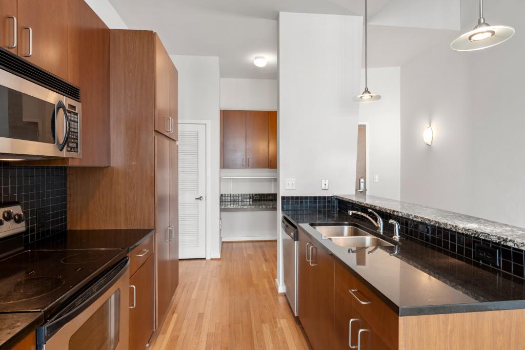 943 Peachtree Street Northeast, Unit 2009 Atlanta, GA 30309 - Photo 6 of 57 a kitchen that has a sink and a stove