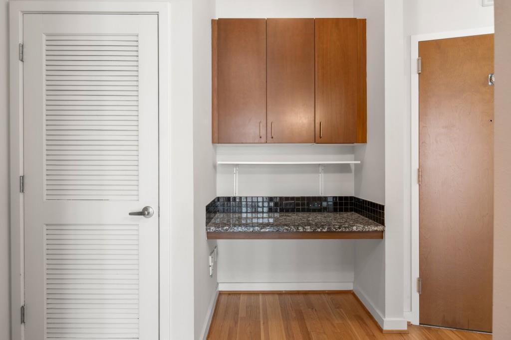 943 Peachtree Street Northeast, Unit 2009 Atlanta, GA 30309 - Photo 7 of 57 a kitchen with a refrigerator and cabinets