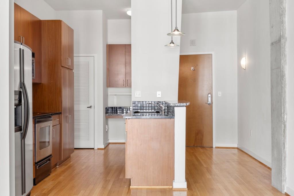 943 Peachtree Street Northeast, Unit 2009 Atlanta, GA 30309 - Photo 9 of 57 a view of kitchen view with refrigerator stove and wooden floor