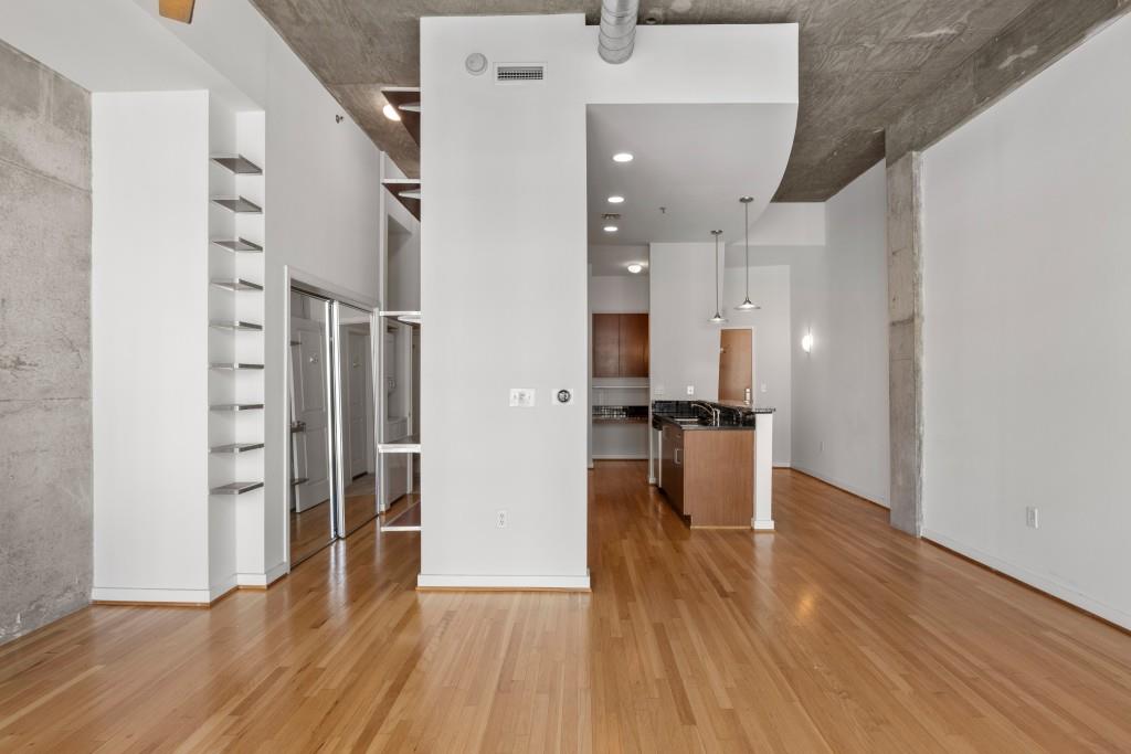 943 Peachtree Street Northeast, Unit 2009 Atlanta, GA 30309 - Photo 10 of 57 an empty room with wooden floor and windows
