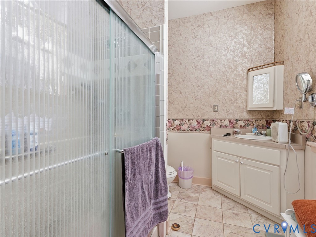 11152 Cross County Road Mineral, VA 23117 - Photo 12 of 29 a bathroom with a sink a toilet and shower