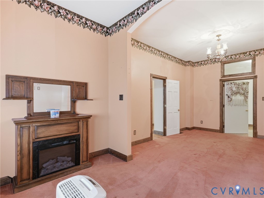 11152 Cross County Road Mineral, VA 23117 - Photo 17 of 29 a view of a livingroom with a fireplace and chandelier