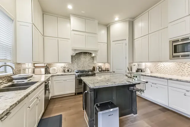 a kitchen with center island white cabinets and center island