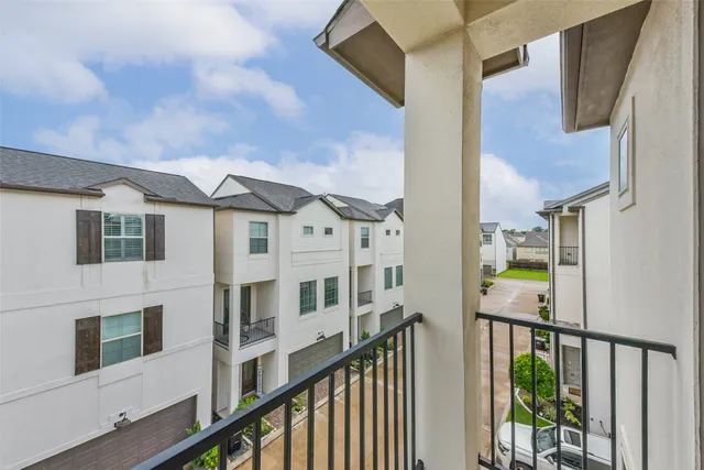 a view of a balcony with wooden floor and fence