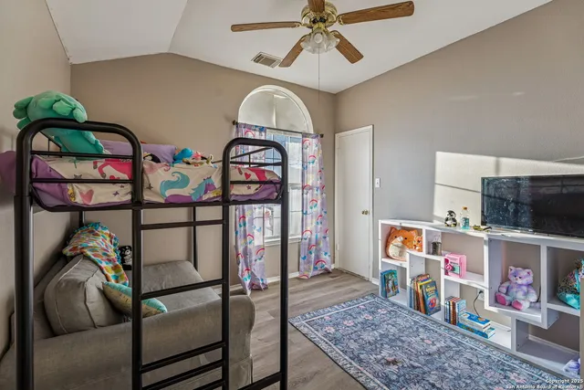 a bedroom with furniture a baby crib and a window