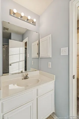 a bathroom with a sink and a mirror