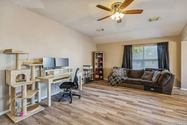 a living room with furniture gym equipment and a window