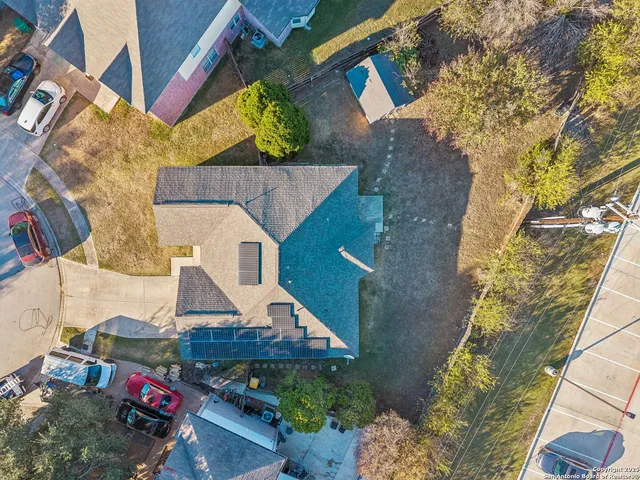 an aerial view of a house with a yard