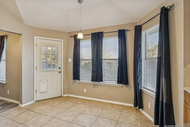 an empty room with windows and closet