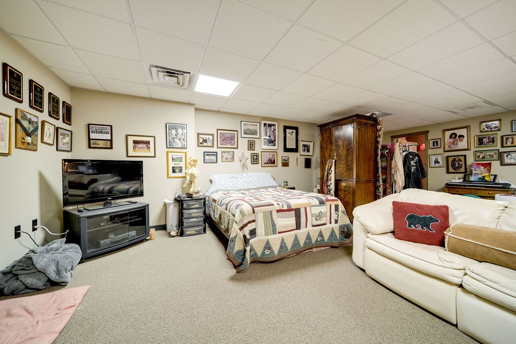 7543 Webster Road White House, TN 37188 - Photo 22 of 29 a spacious bedroom with a bed a couch and bookshelf