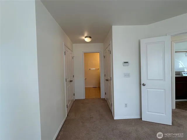 a view of a hallway with closet area