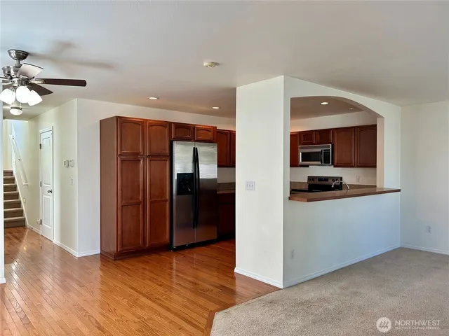 a view of kitchen with refrigerator and window