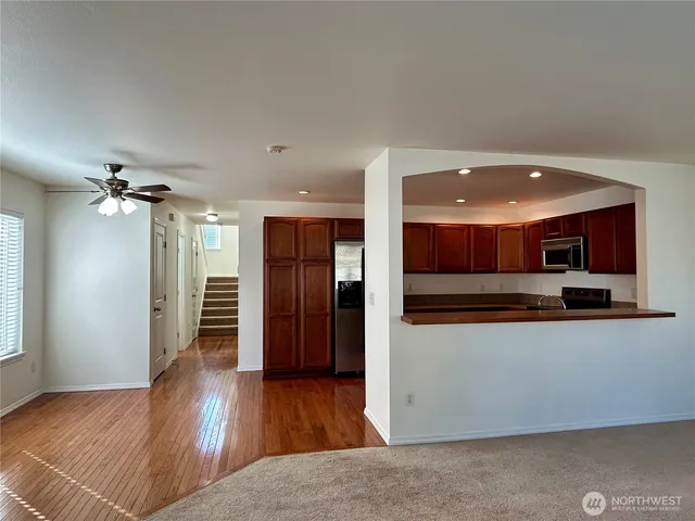 a view of a kitchen with a sink and a refrigerator