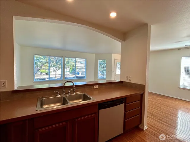 a kitchen with a sink a window and cabinets