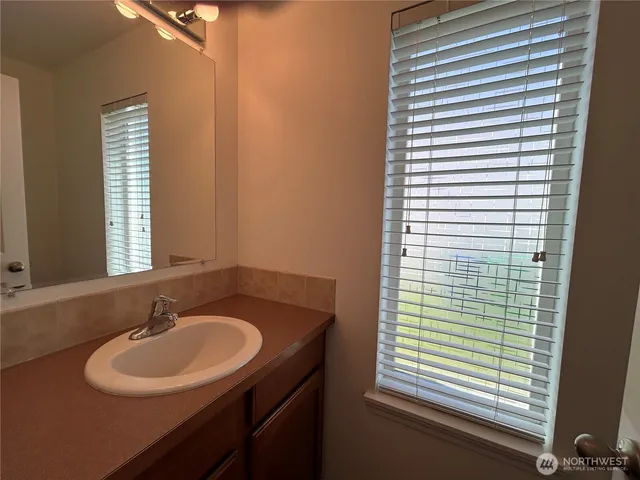 a bathroom with a sink and a window